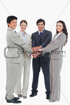 Smiling businessteam putting their hands together