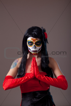 Praying woman with sugar skull make-up 
