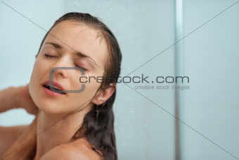 Portrait of relaxed woman taking shower