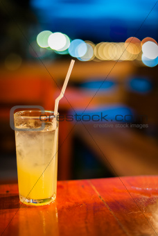 Orange juice on table wilth color of light