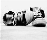 A pair of sneakers on the floor in black and white