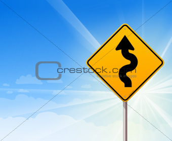 Winding road sign on blue sky