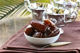 sweet dates in bowl on a natural background
