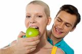Love couple. Girlfriend eating an apple