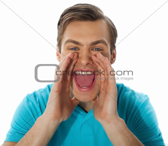 Exciting young handsome man shouting