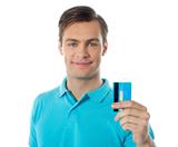 Close-up of handsome guy holding a credit card