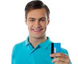 Close-up portrait of fashionable guy holding debit card