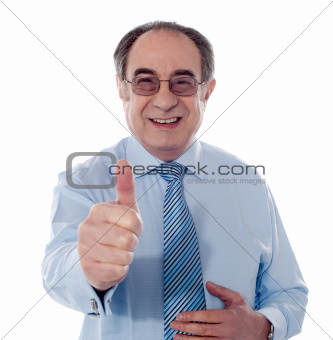 Smiling mature businessman showing thumbs-up