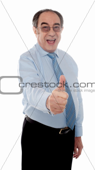 Happy senior manager posing with thumbs-up gesture