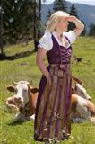 Young woman in dirndl on the farm