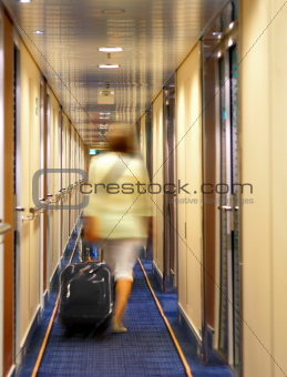 woman with suitcase in hotel