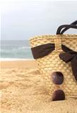Seacoast, straw beach bag and sunglasses 	