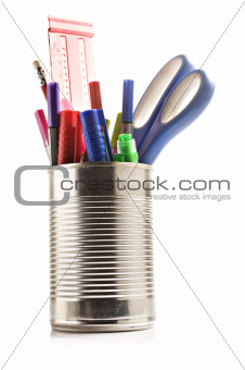 Stationery in a tin can on white