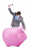 Young businessman and piggy bank