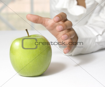 taking a fresh green apple