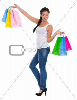 Full length portrait of happy girl with shopping bags