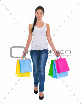 Smiling girl walking with shopping bags
