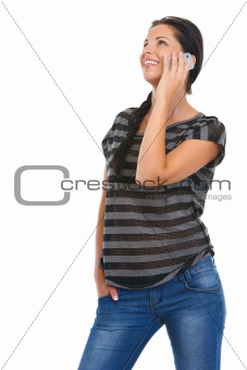 Smiling girl speaking mobile phone and looking on copy space