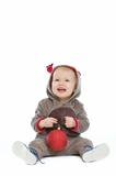 Smiling baby with Christmas ball looking up on copy space