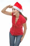 Young woman in Christmas hat looking into distance