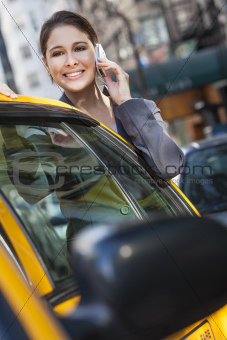 Young Woman Talking on Cell Phone By Yellow Taxi