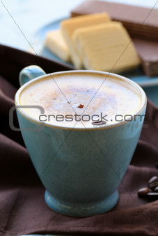 coffee cappuccino in a  blue ceramic cup