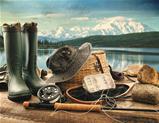 Fly fishing equipment on deck with view of a lake and mountains
