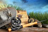 Fly fishing equipment with hat on wooden dock
