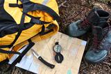 Hiking shoes on map with compass