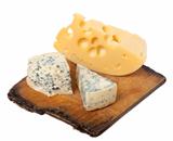 Various types of cheese on old wooden kitchen board