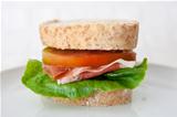 Sandwich of cured ham, tomatoes and lettuce
