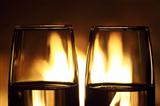 two glasses in front of fireplace