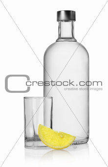 Bottle of vodka and lemon isolated