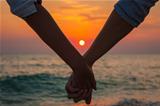 Couple Holding Hands at Sea Sunset
