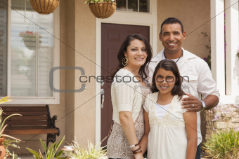 Hispanic Mother, Father and Daughter in Front of Their Home.