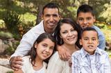 Happy Attractive Hispanic Family Portrait Outdoors In the Park.