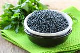 Beluga black lentils in a bowl on a wooden table