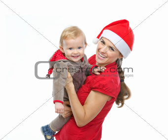 Portrait of mother in Santa's hat playing with baby