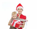 Mother in Santa's hat holding baby opening Christmas present