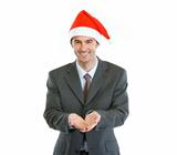Smiling businessman in Santa's hat presenting something on empty hand