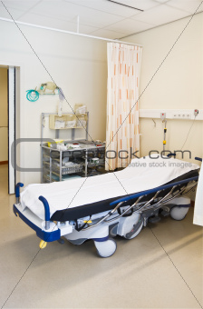 First aid in hospital with bed and medical equipment