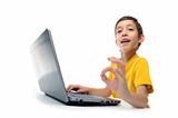 young boy in yellow t-shirt with laptop showing ok at camera iso