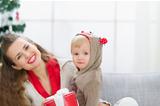 Happy young mother and baby spending Christmas time together