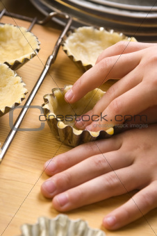Detail of child hands making cookies