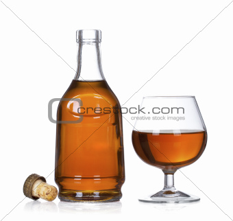 Cognac brandy bottle and glass isolated on white background