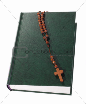 Wooden rosary on the Bible