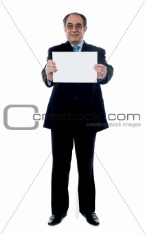 Senior business professional holding blank billboard