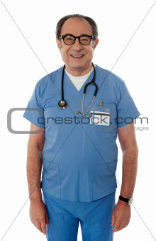 Handsome smiling senior doctor posing in front of camera
