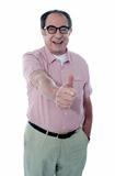 Smiling aged male gesturing thumbs-up