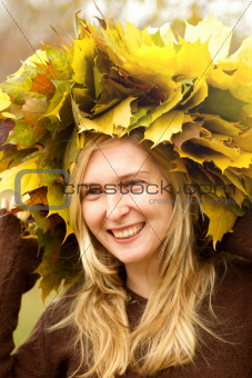 Woman with autumn wreath outdoors
